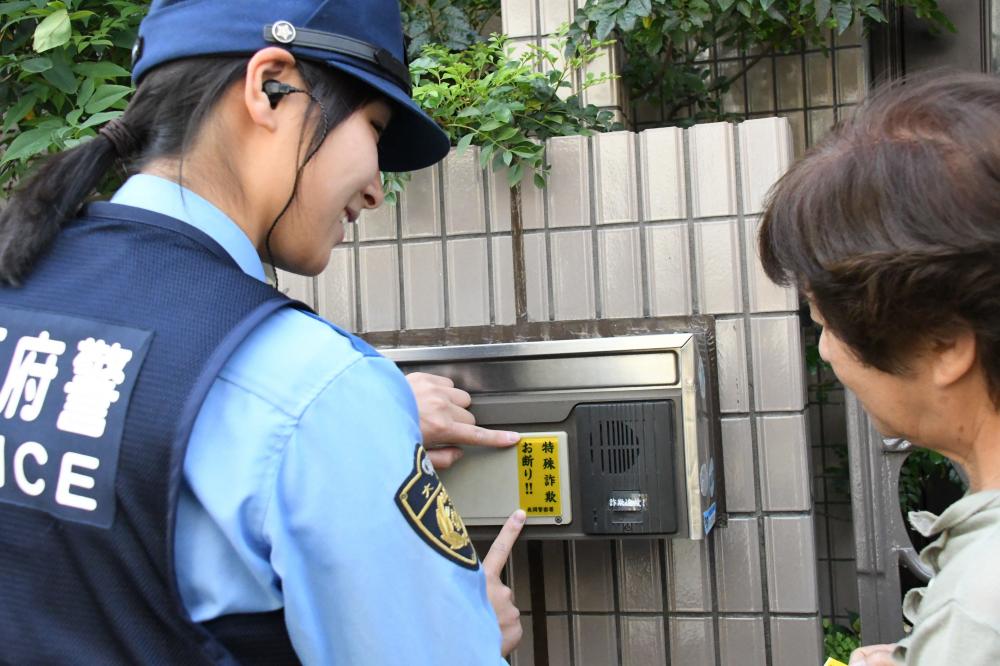 ステッカーを貼る警察官