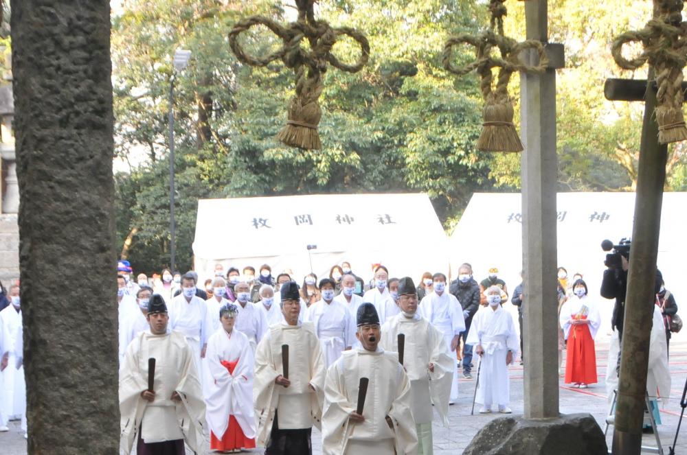 しめ縄の前に宮司らがならぶ様子